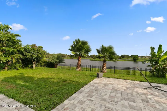 a green field with lots of trees in background