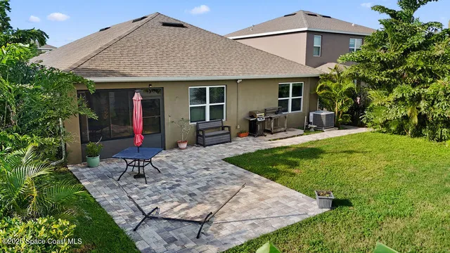 a view of a house with backyard porch and sitting area