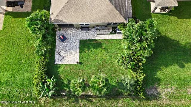 an aerial view of a house with a yard basket ball court and outdoor seating