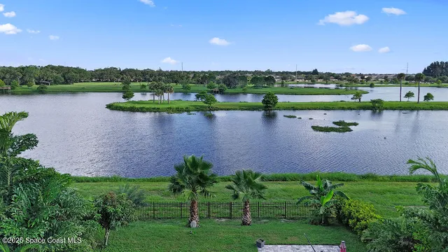 a view of a lake with houses in the back