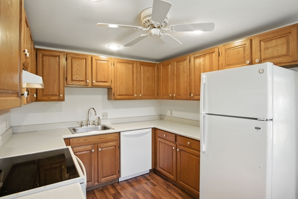 8 Devlin Circle, Unit 8 Blackstone, MA 01504 - Photo 13 of 38 a white kitchen with sink a refrigerator and cabinets