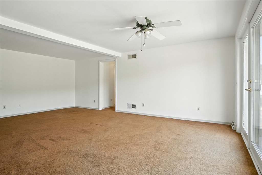 8 Devlin Circle, Unit 8 Blackstone, MA 01504 - Photo 15 of 38 an empty room with a ceiling fan and a window