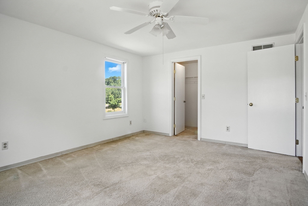 8 Devlin Circle, Unit 8 Blackstone, MA 01504 - Photo 18 of 38 an empty room with windows and fan