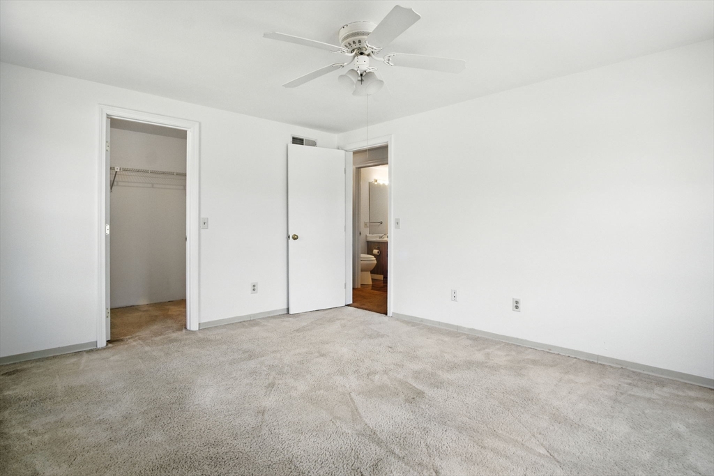 8 Devlin Circle, Unit 8 Blackstone, MA 01504 - Photo 19 of 38 an empty room with a ceiling fan and a window