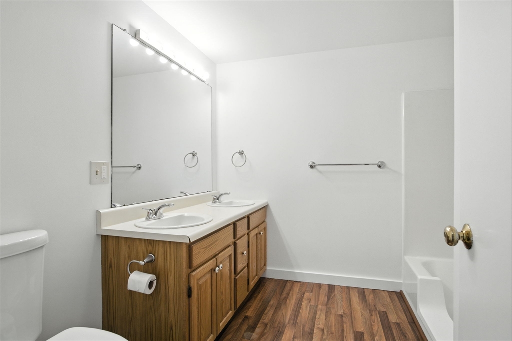 8 Devlin Circle, Unit 8 Blackstone, MA 01504 - Photo 24 of 38 a bathroom with a sink and mirror