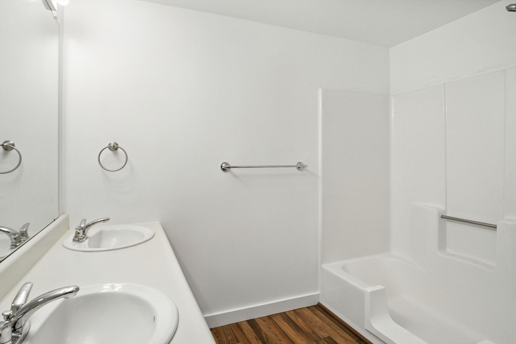 8 Devlin Circle, Unit 8 Blackstone, MA 01504 - Photo 25 of 38 a bathroom with a sink and a mirror