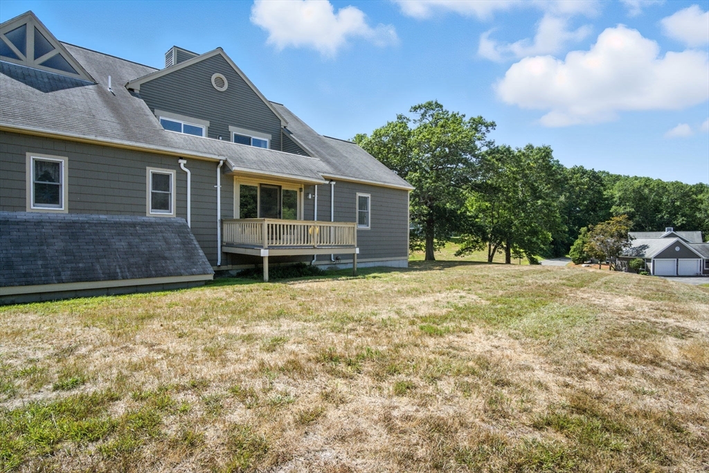 8 Devlin Circle, Unit 8 Blackstone, MA 01504 - Photo 27 of 38 a front view of a house with a yard