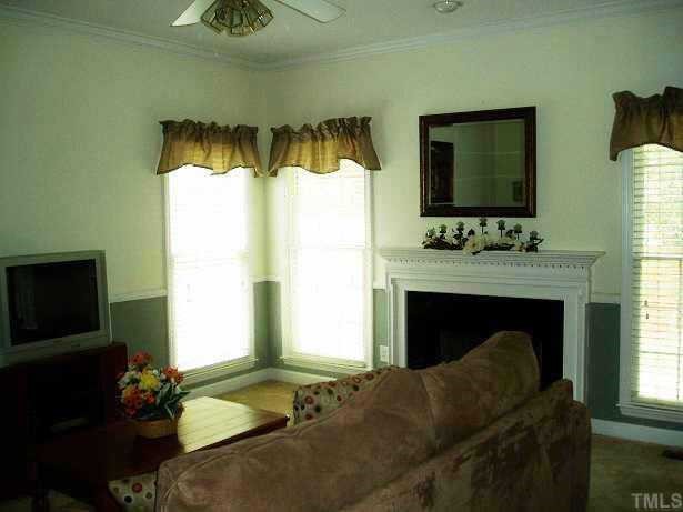 7020 Edgeview Court Raleigh, NC 27613 - Photo 2 of 8 a living room with furniture and a fireplace
