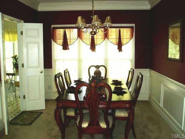 7020 Edgeview Court Raleigh, NC 27613 - Photo 3 of 8 a view of a dining room with furniture and chandelier