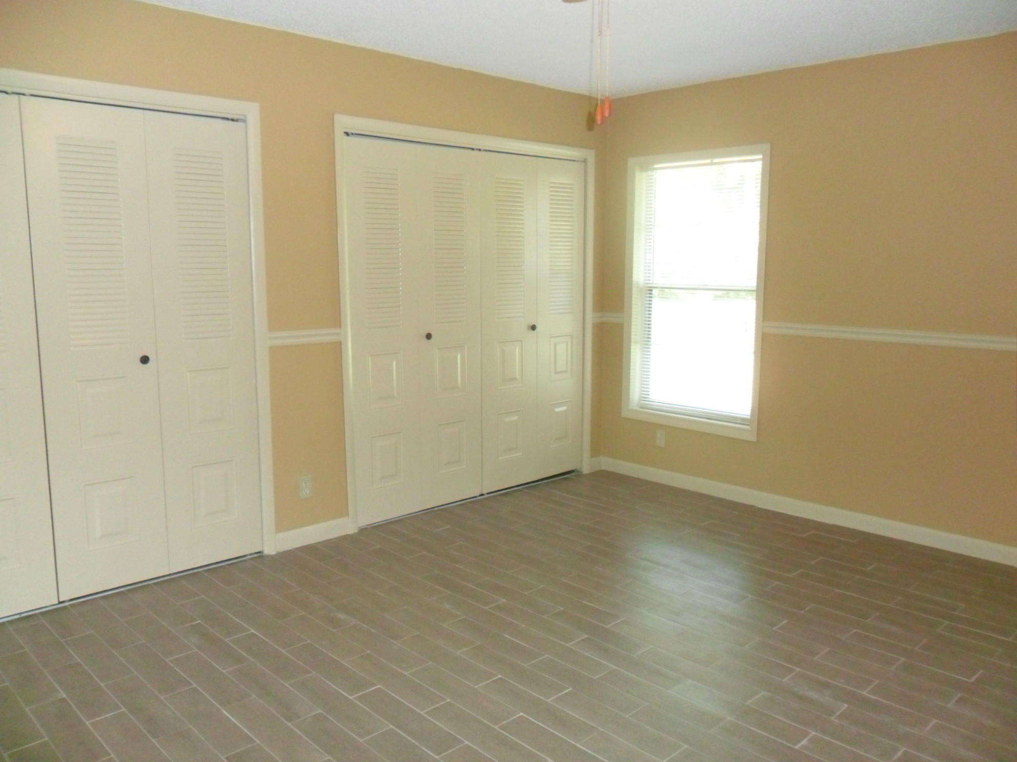 6311 Lasalle Road Delray Beach, FL 33484 - Photo 24 of 34 a view of an empty room with wooden floor and a window