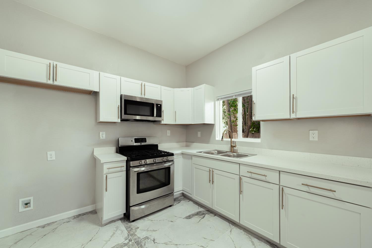 2320 K Street Merced, CA 95340 - Photo 4 of 25 a kitchen with a sink stove and microwave