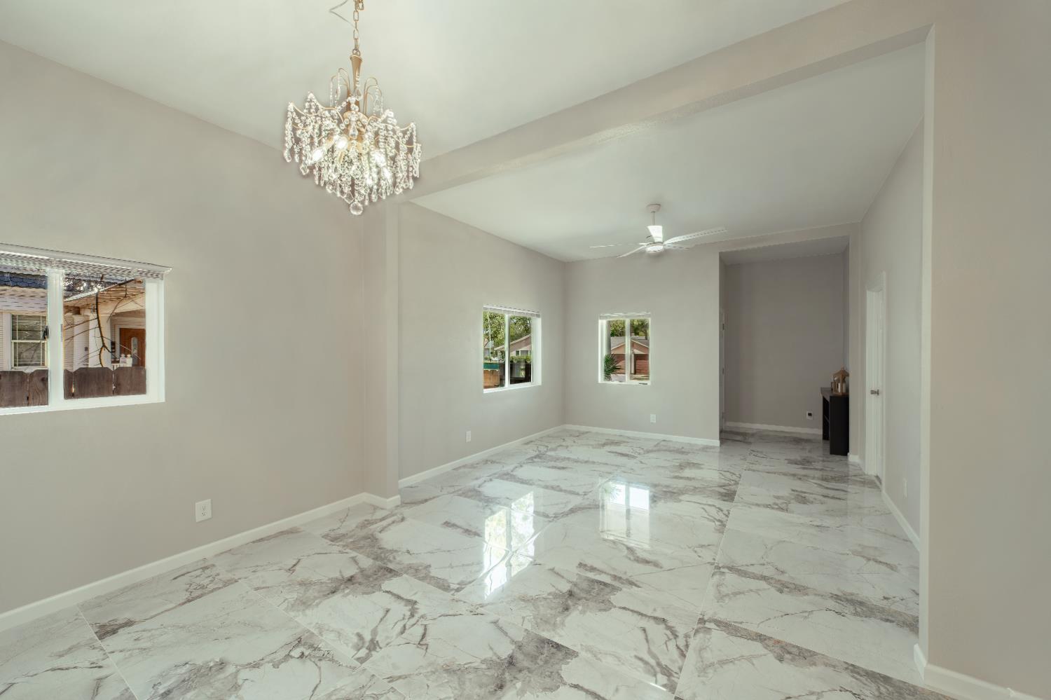 2320 K Street Merced, CA 95340 - Photo 7 of 25 a view of a big room with windows and chandelier