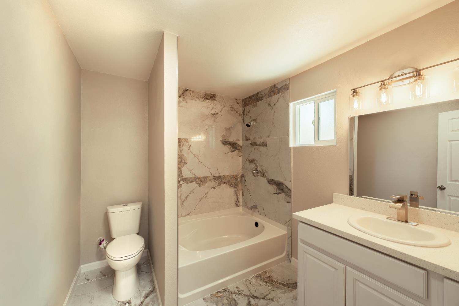2320 K Street Merced, CA 95340 - Photo 9 of 25 a bathroom with a sink a toilet and shower