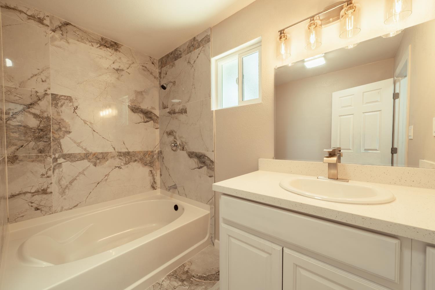 2320 K Street Merced, CA 95340 - Photo 10 of 25 a bathroom with a bathtub and a sink
