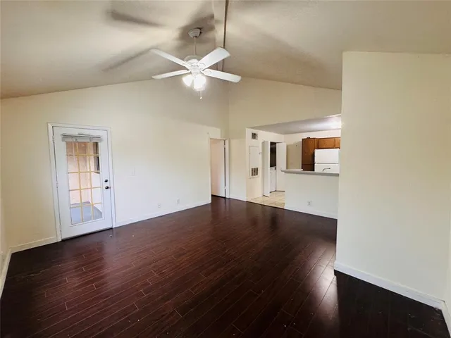 a view of a livingroom with wooden floor and a ceiling fan