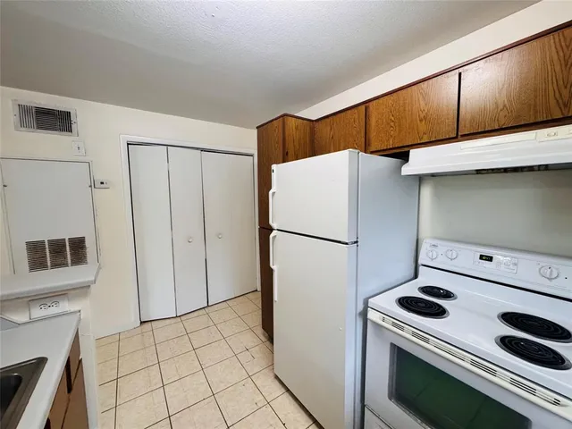a kitchen with a refrigerator and a stove