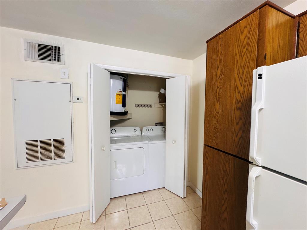 4090 North Pine Island Road, Unit 301 Sunrise, FL 33351 - Photo 10 of 16 a kitchen with a refrigerator and a stove