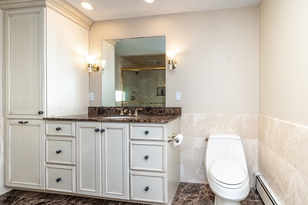 64 Garland Road Newton, MA 02459 - Photo 18 of 27 a bathroom with a toilet a sink and a mirror