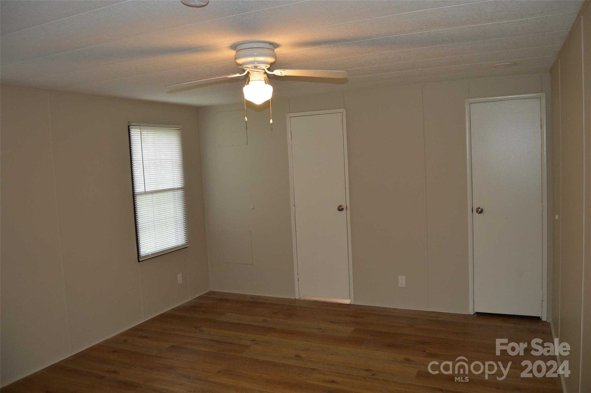 613 West Lewis Ferry Road Statesville, NC 28677 - Photo 11 of 22 an empty room with wooden floor and windows