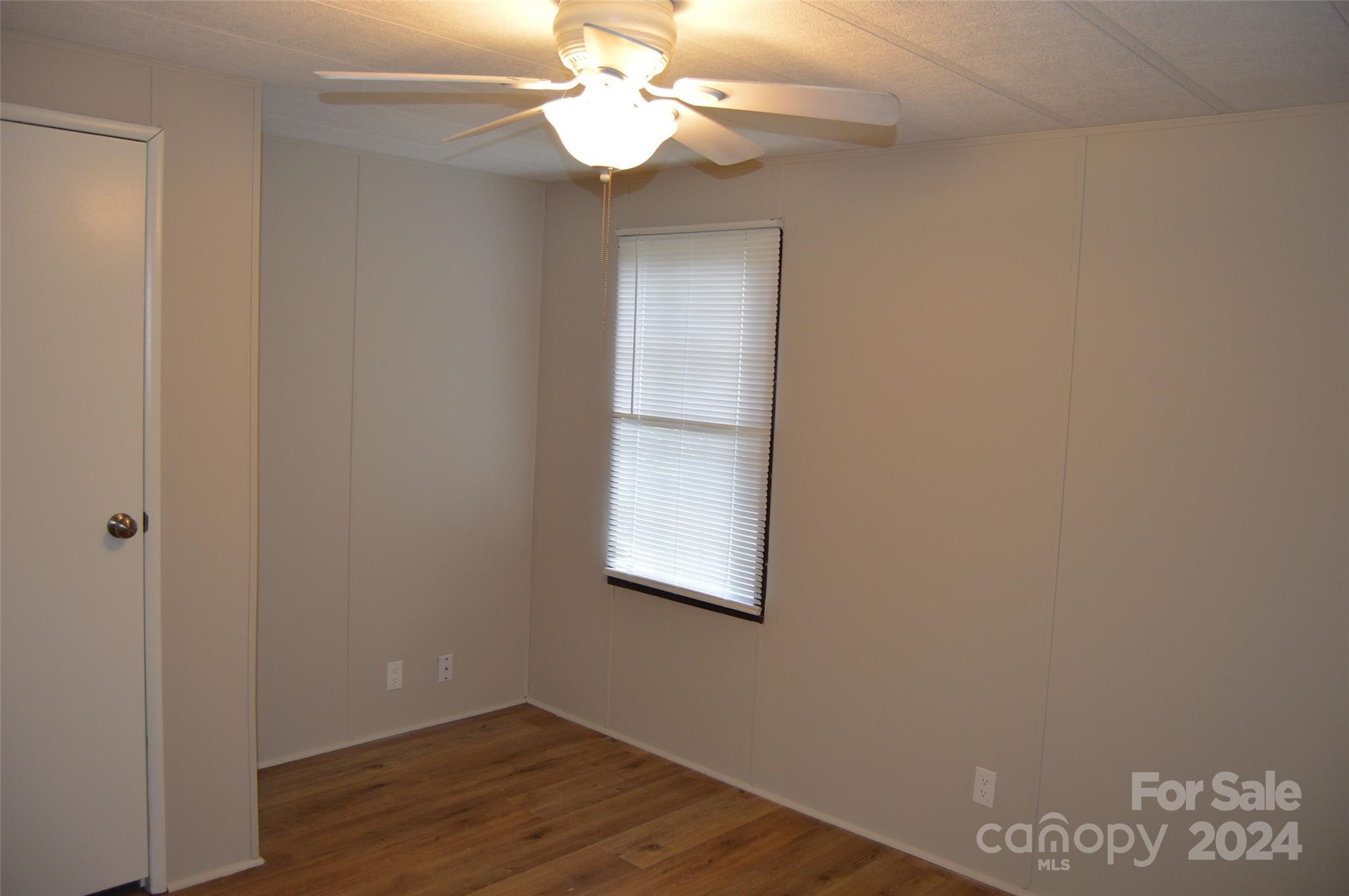 613 West Lewis Ferry Road Statesville, NC 28677 - Photo 18 of 22 a view of a room with wooden floor and fan