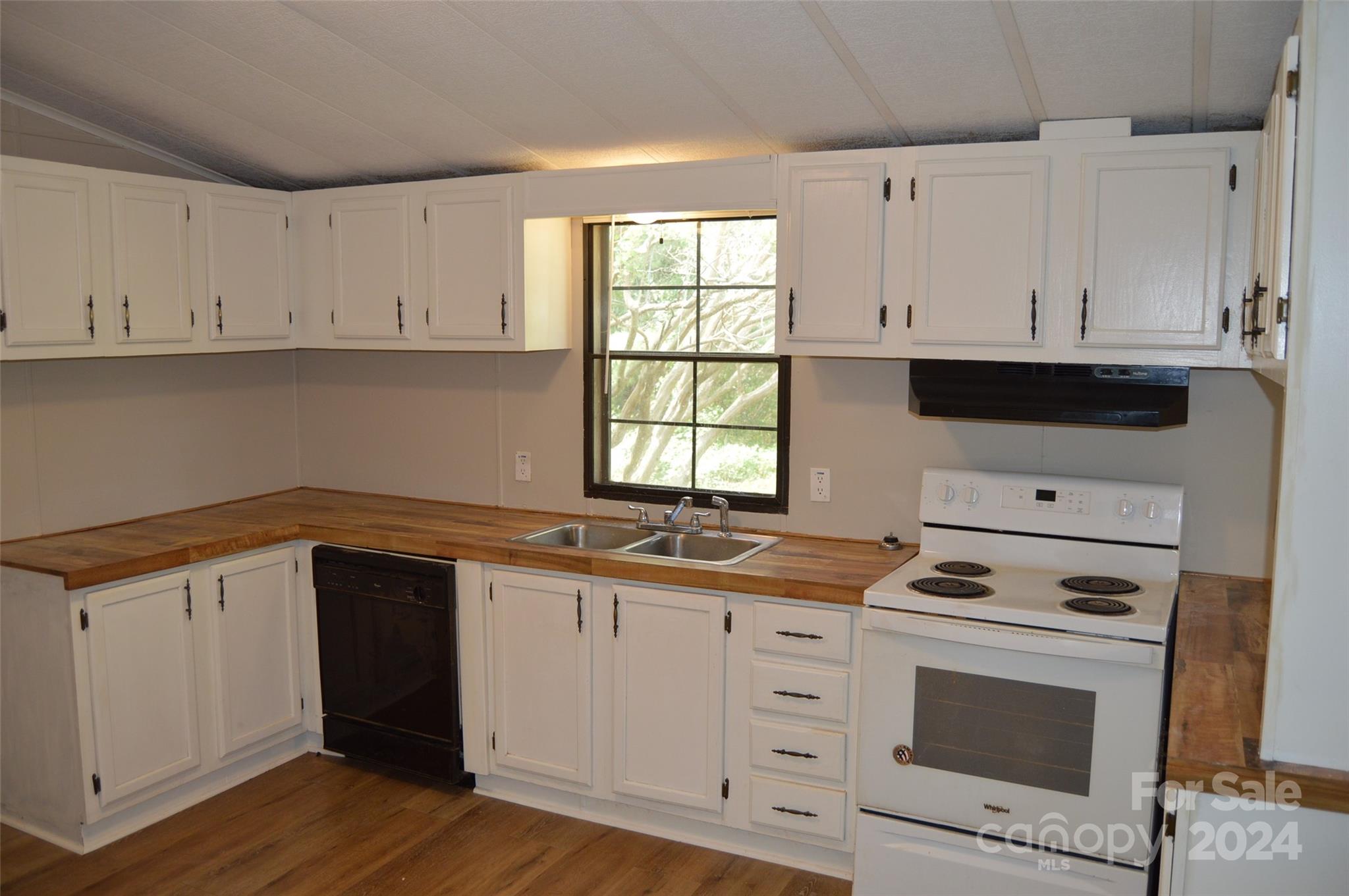 613 West Lewis Ferry Road Statesville, NC 28677 - Photo 7 of 22 a kitchen with granite countertop white cabinets and white appliances
