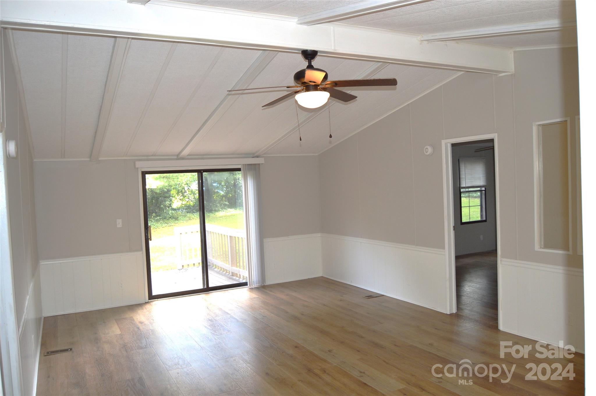 613 West Lewis Ferry Road Statesville, NC 28677 - Photo 8 of 22 a view of an empty room with wooden floor and a window