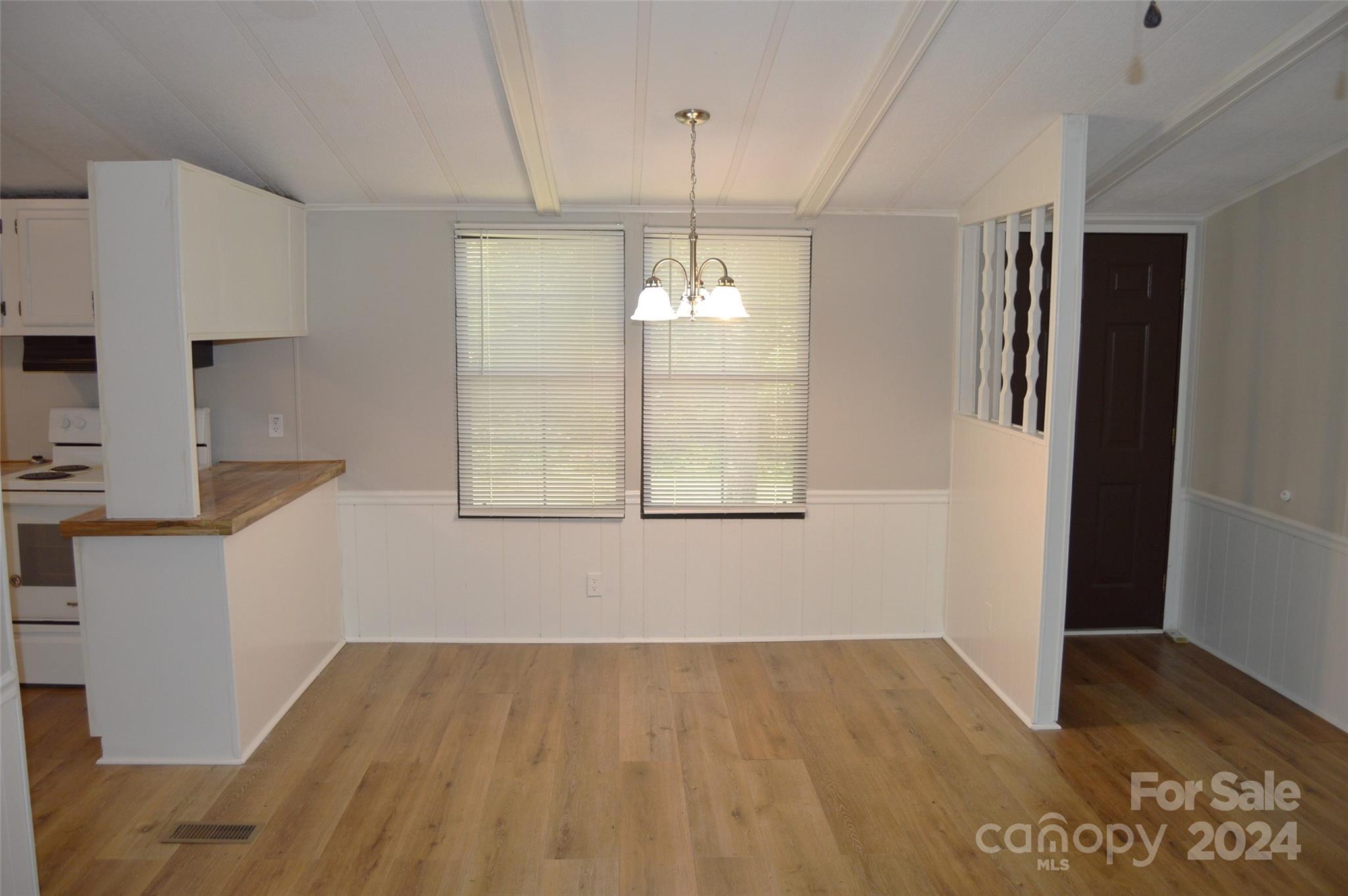 613 West Lewis Ferry Road Statesville, NC 28677 - Photo 9 of 22 a view of a kitchen with wooden floor and windows