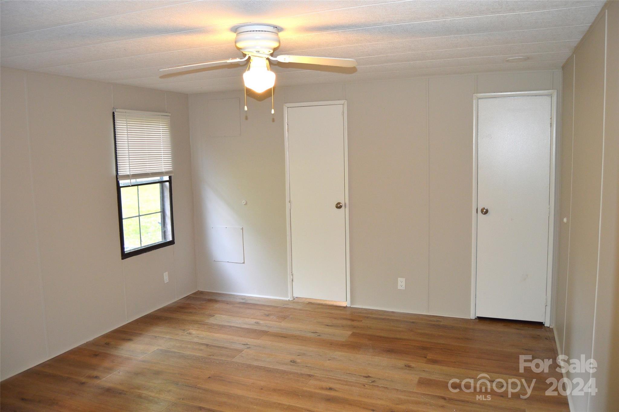 613 West Lewis Ferry Road Statesville, NC 28677 - Photo 10 of 22 a view of an empty room with wooden floor and a window
