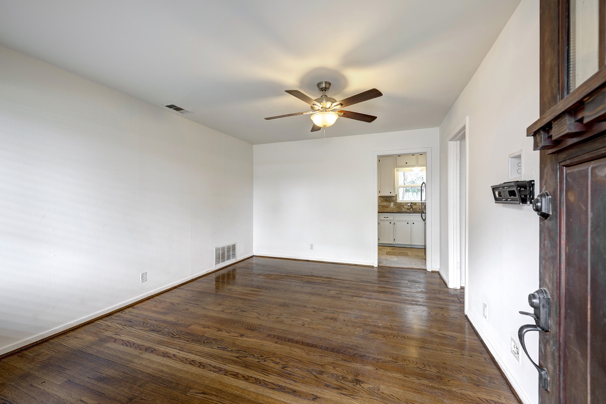 4722 Carleen Road Houston, TX 77092 - Photo 2 of 13 wooden floor in an empty room with a window