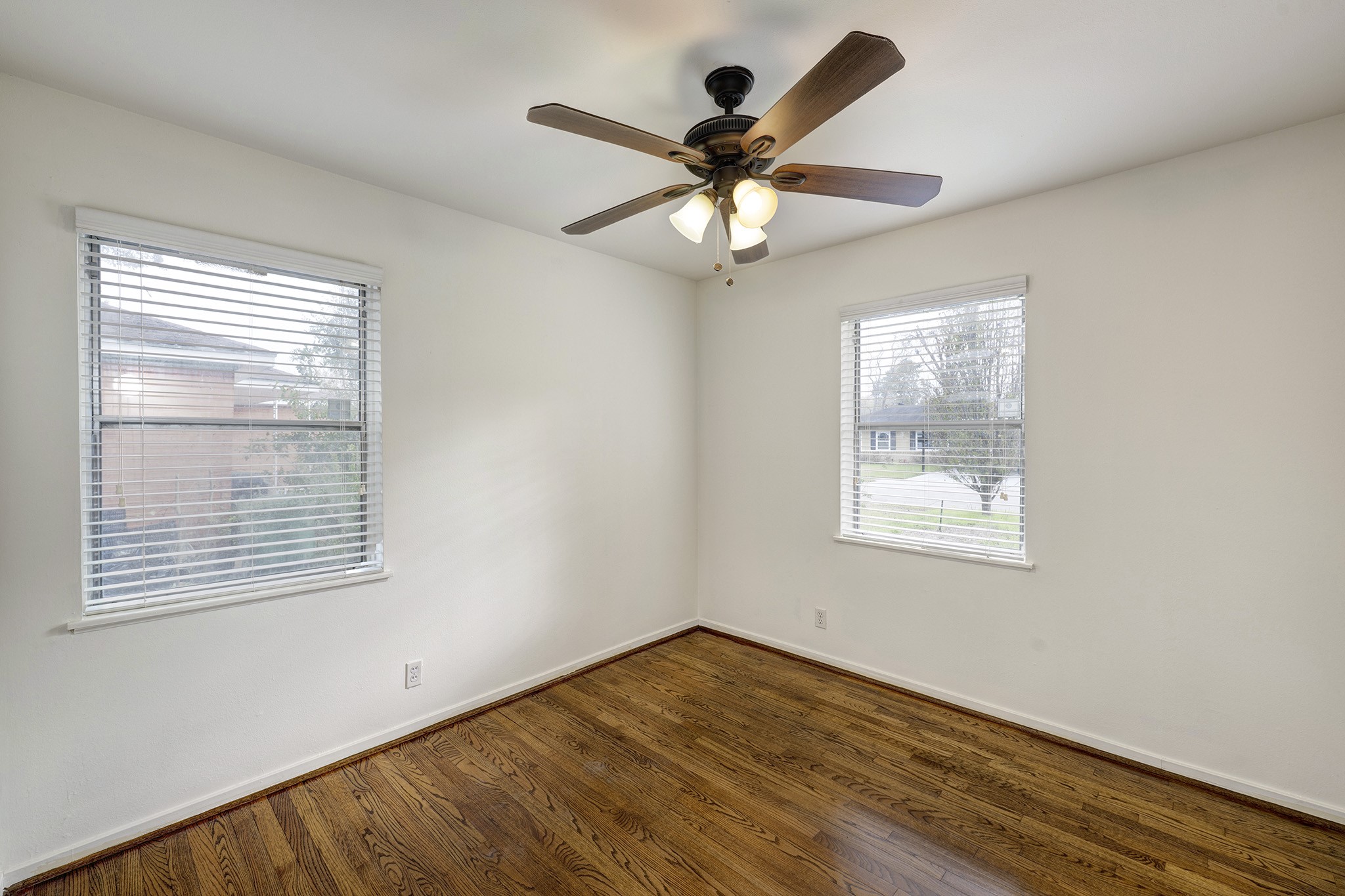 4722 Carleen Road Houston, TX 77092 - Photo 8 of 13 a view of an empty room with wooden floor and a window