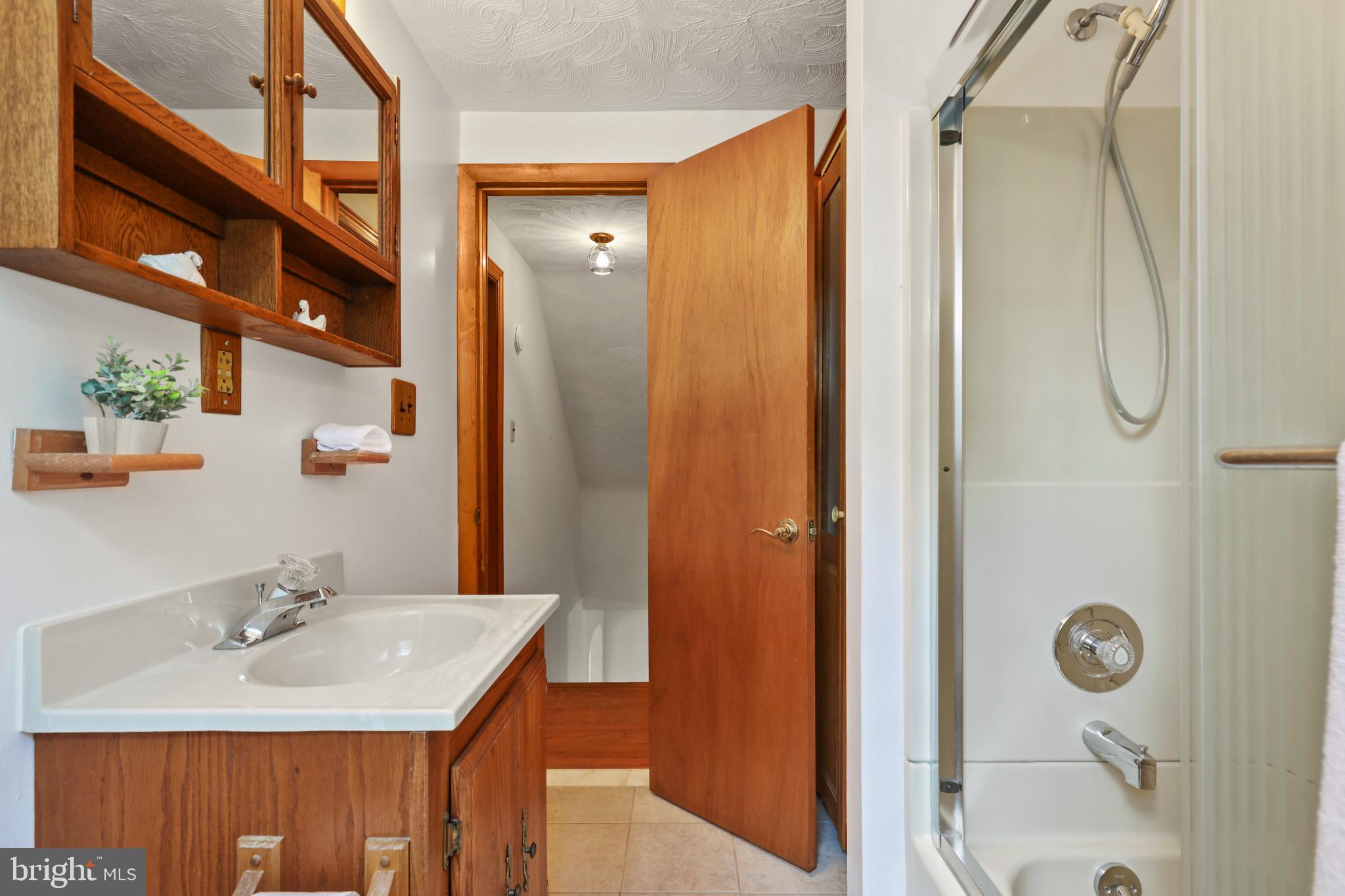 1058 Minnetonka Road Severn, MD 21144 - Photo 62 of 96 Tile floor, tub surround, shower doors & heat lamp