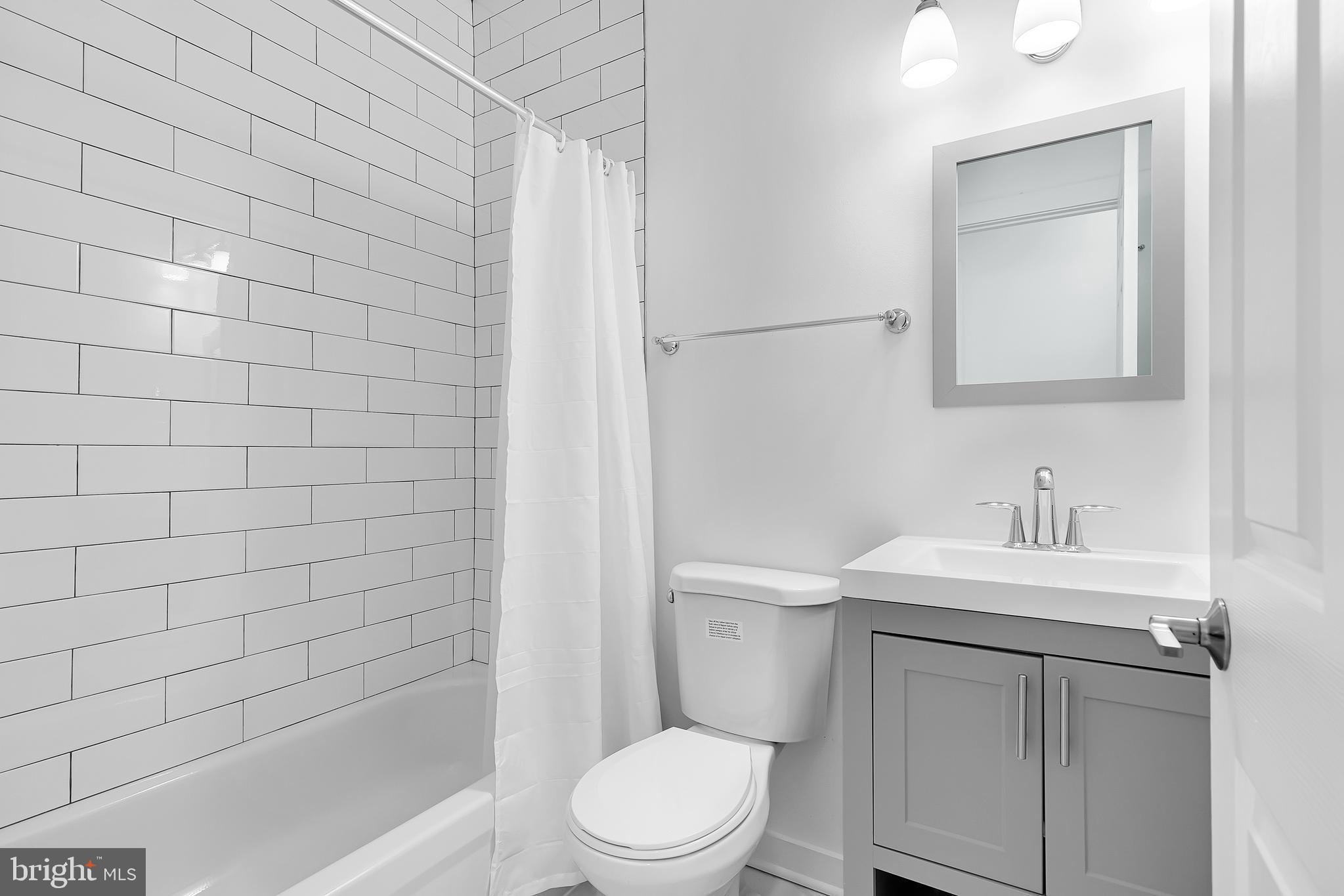 1712 3rd Street Northwest Washington, DC 20001 - Photo 23 of 32 a bathroom with a sink a toilet and shower