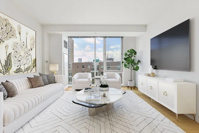 a living room with furniture a flat screen tv and a large window