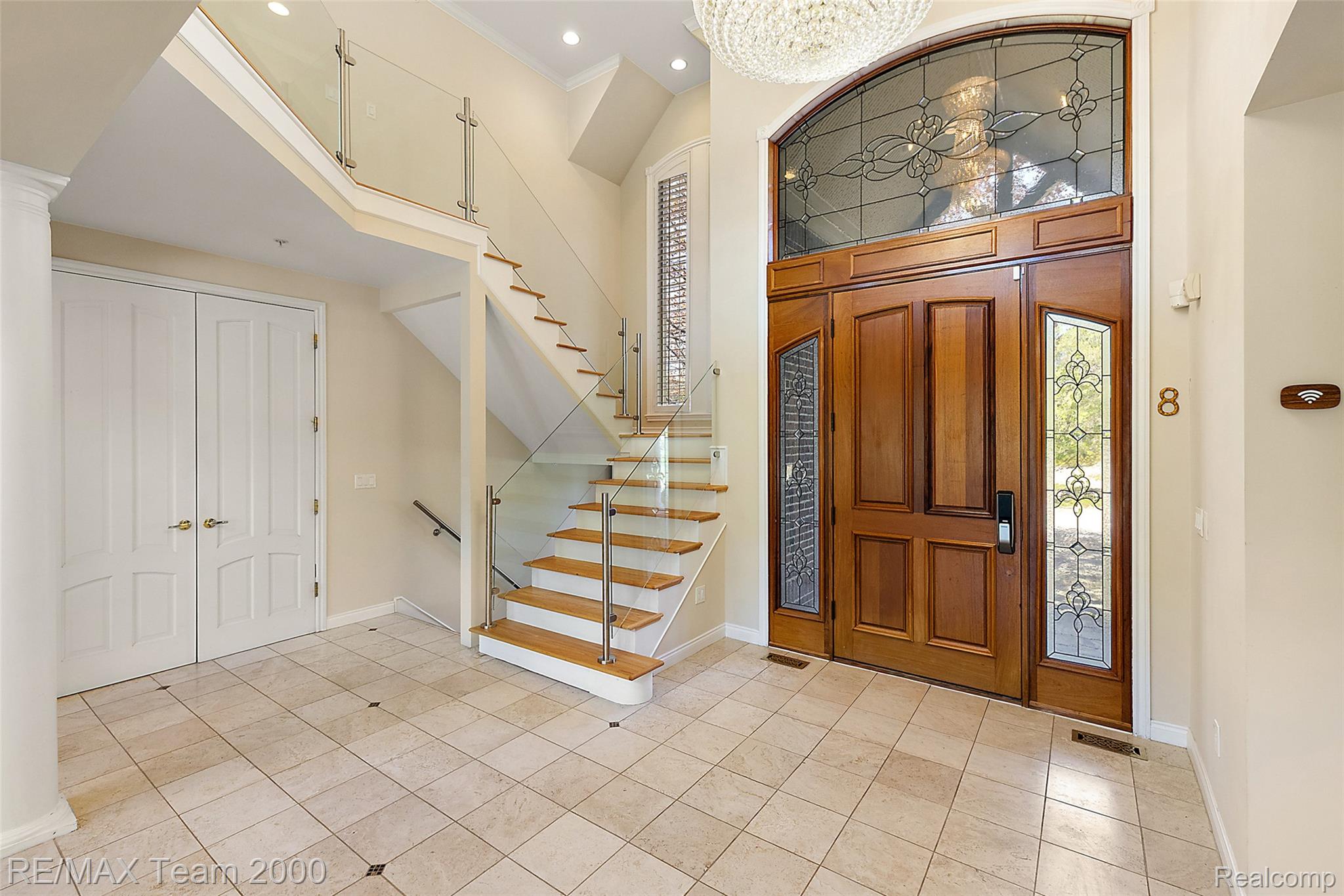 630 Sheldon Court Rochester, MI 48306 - Photo 16 of 94 Entrance foyer with light tile patterned floors, ornamental molding, a high ceiling, recessed lighting, and ornate columns