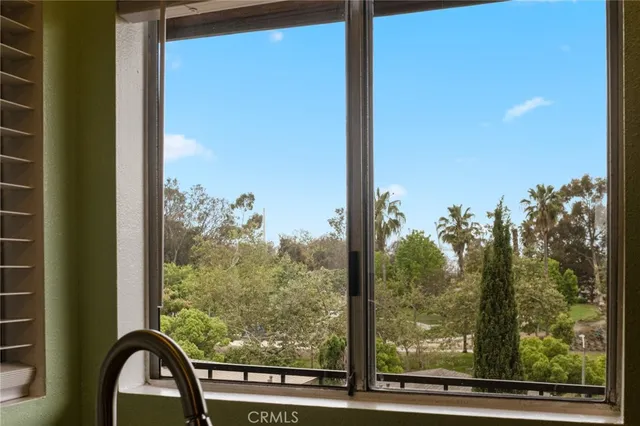 a view of a room with a large window and front door