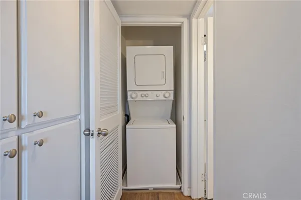 a view of a room with a large window and front door