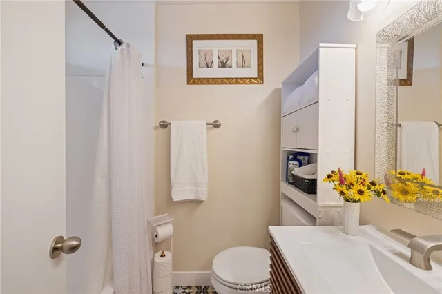 a white toilet sitting next to a bathroom sink