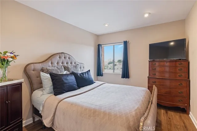 a bedroom with a bed and a flat screen tv