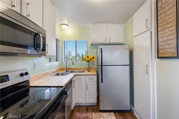 a kitchen with a refrigerator and a sink