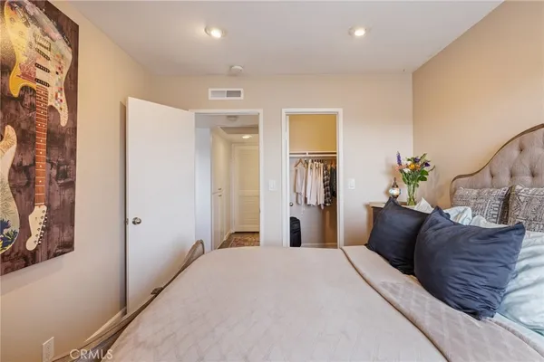 a bedroom with a large bed and a window