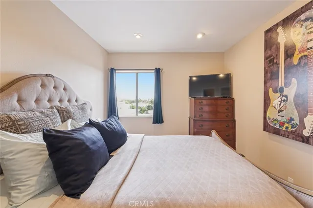 a bedroom with a bed and a painting on the wall