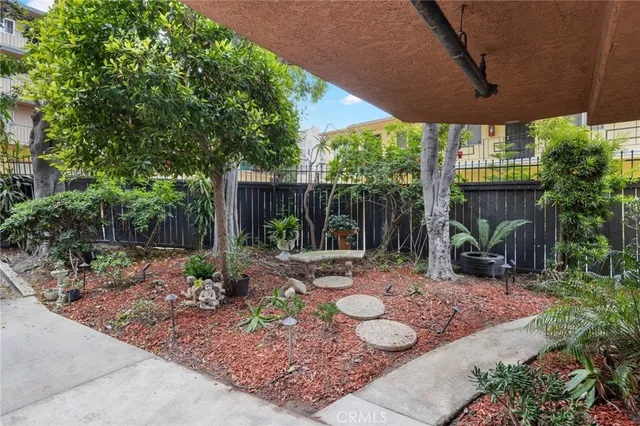 a building outdoor space with patio furniture and potted plants