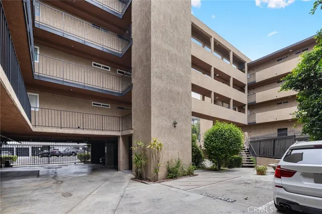 a front view of a house with a yard and potted plants