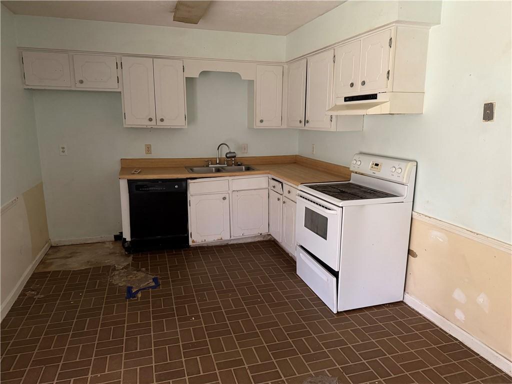 1765 Highpoint Road Snellville, GA 30078 - Photo 4 of 11 a kitchen with granite countertop white cabinets and white appliances