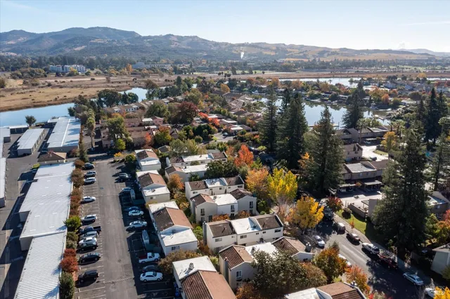 an aerial view of residential houses with city view