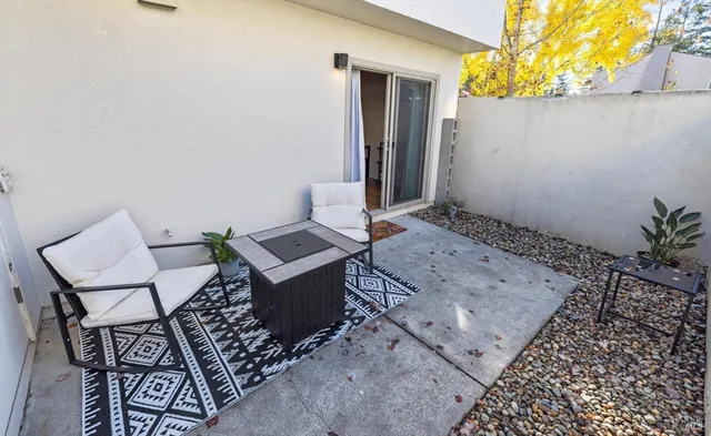 a living room with furniture a flat screen tv and a kitchen