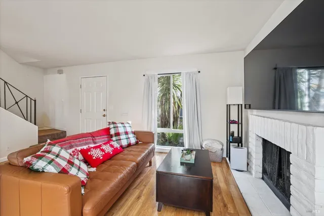 a kitchen with stainless steel appliances granite countertop a refrigerator a sink and a stove with wooden floor