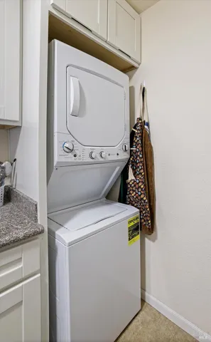 a bathroom with a granite countertop toilet a sink and a mirror