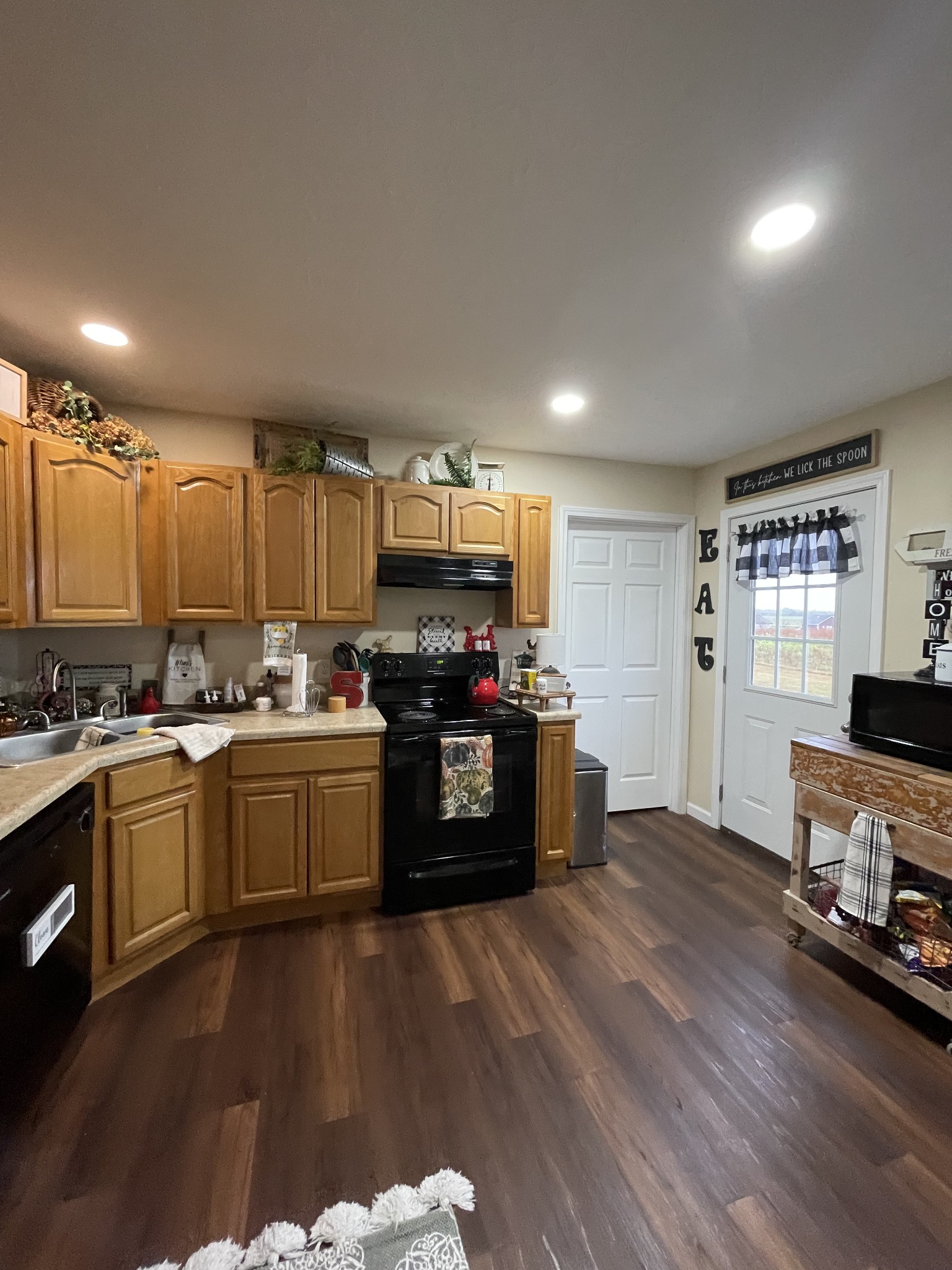 914 Freeman Street Lafayette, TN 37083 - Photo 5 of 12 a kitchen with a refrigerator and a stove top oven