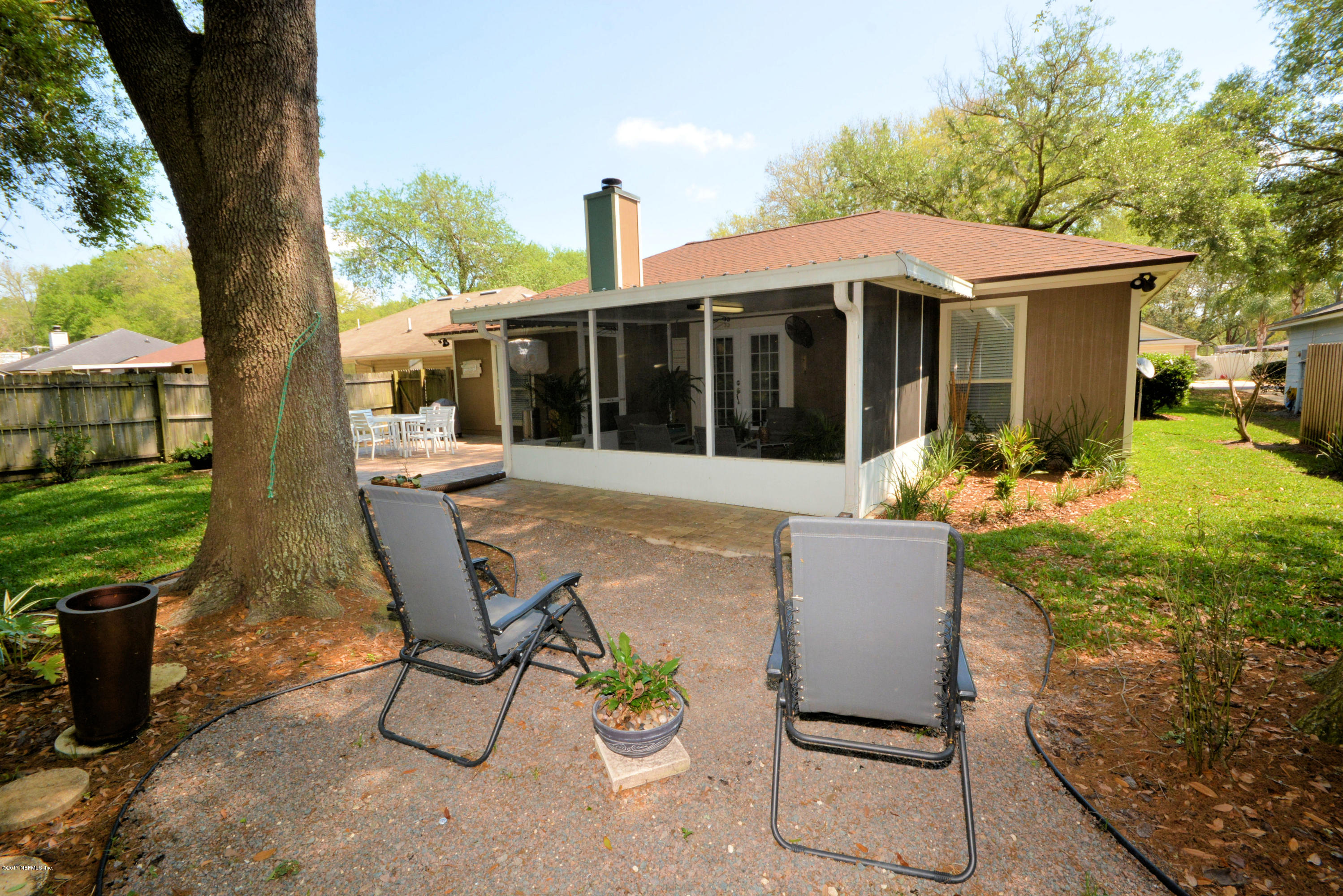 12744 Moose Road Jacksonville, FL 32226 - Photo 30 of 33 a view of a house with backyard sitting area and garden